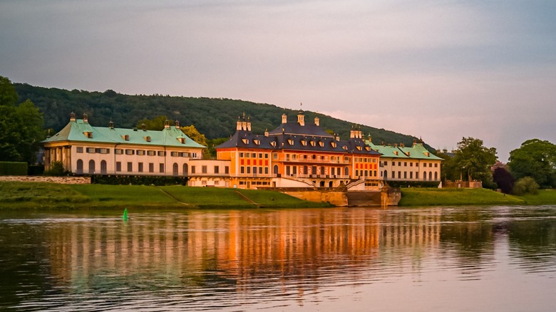 The three palaces of Pillnitz Palace and Park, along the Elbe River in Dresden, Germany, at sunset