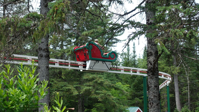 White, red, and green sleigh ride in the trees at Santa's Village in New Hampshire