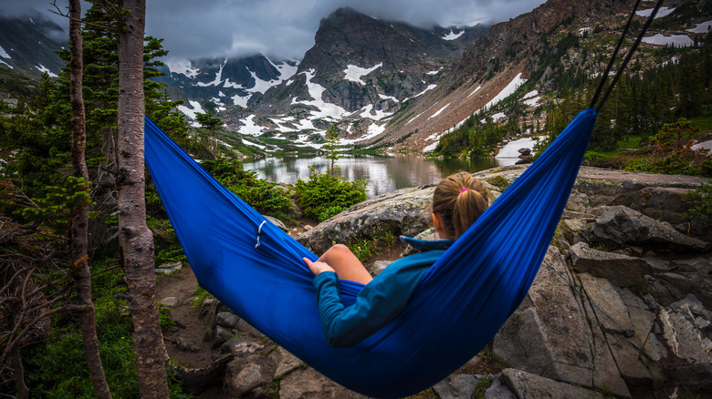 A person relaxing in a hammock near Brainard Lake