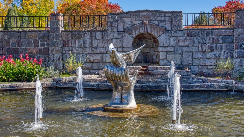 chrome sculpture dove in fountain pool