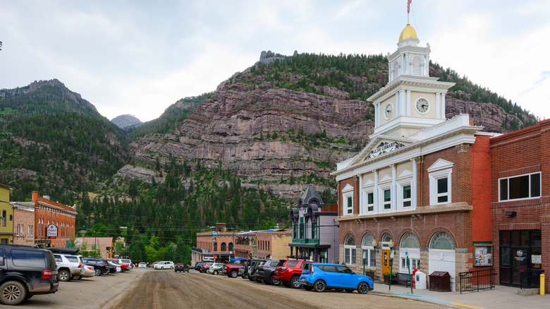 View of a road in Ouray, Colorado with a church and mountains as backdrop