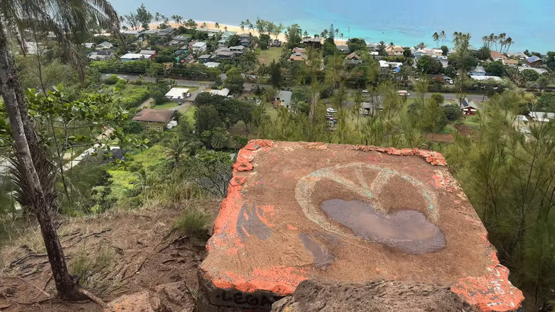 the Peace sign pillbox overlooking a small row of housee and a beach