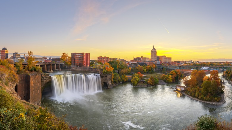 An aerial view of High Falls, New York, featuring a waterfall, trees, and buildings