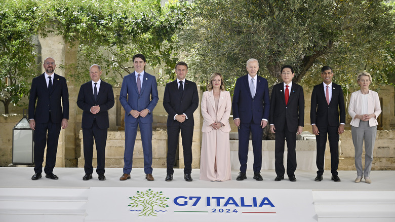 leaders of the G7 2024 pose for a photo in front of an olive tree at the Borog Egnazia