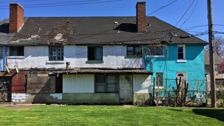 A worn-down blue and white house in Marktown