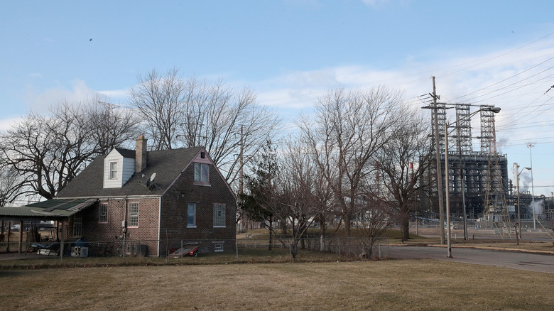 BP refinery, a brown building, and bare trees near Marktown, Indiana