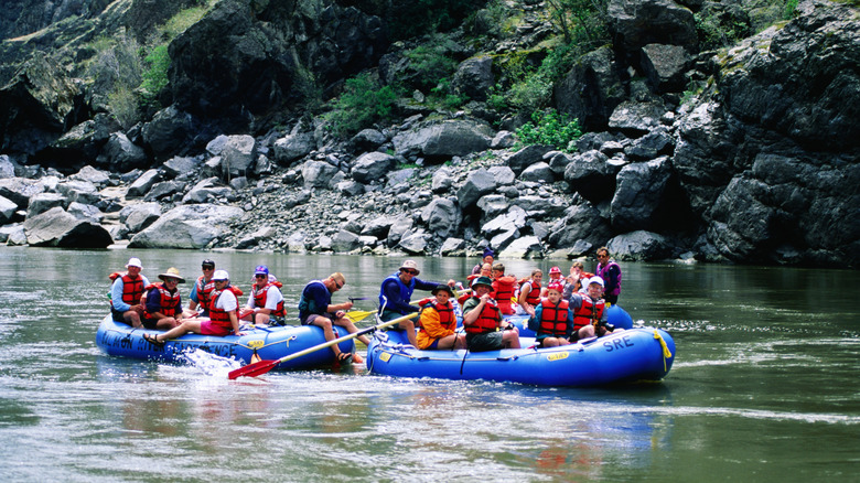 People on a white rafting tour with two large vessels