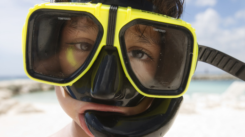 Closeup of a kid wearing snorkeling gear