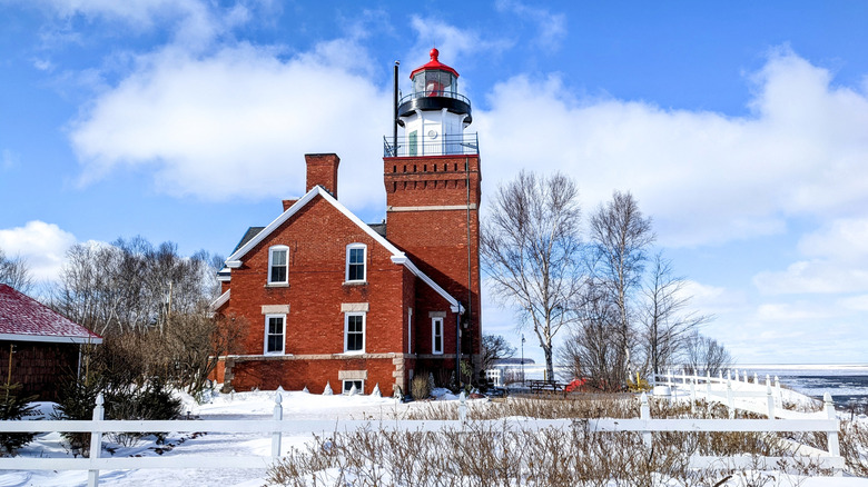 Big Bay Point Lighthouse in the winter with blue skies