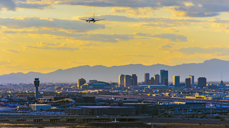 Phoenix Sky Harbor Airport at sunset with mountains.