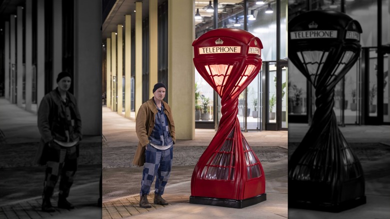 Alex Chinneck stands with his sculpture, "Wring Ring", located in front of Assembly Bristol's Building A in Bristol, U.K.