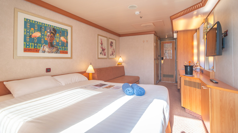 Bed and desk in cabin room interior of Costa Cruises