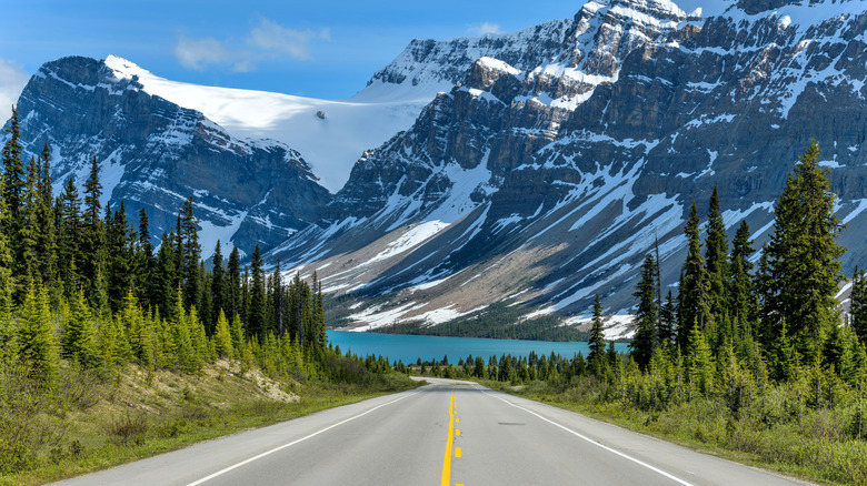 View of a lake surrounded by snow peaks from the Icefields Parkway