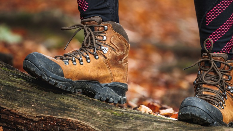 A hiker wears a pair of hiking boots on forest trail