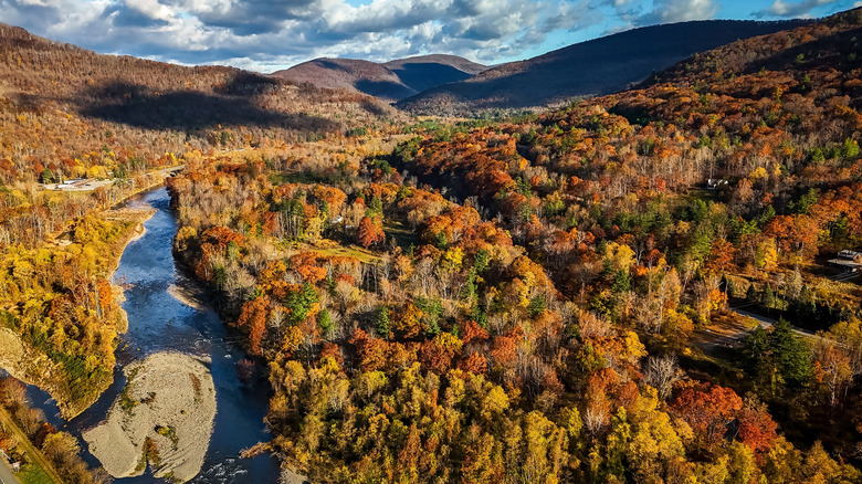 Aerial view of fall foilage and a river in the Catskills.