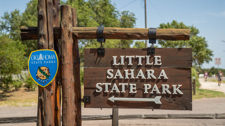 Little Sahara State Park sign with trees in the background