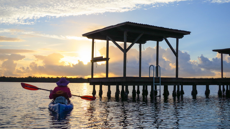 Woman paddles kayak to camping chickee in Everglades National Park