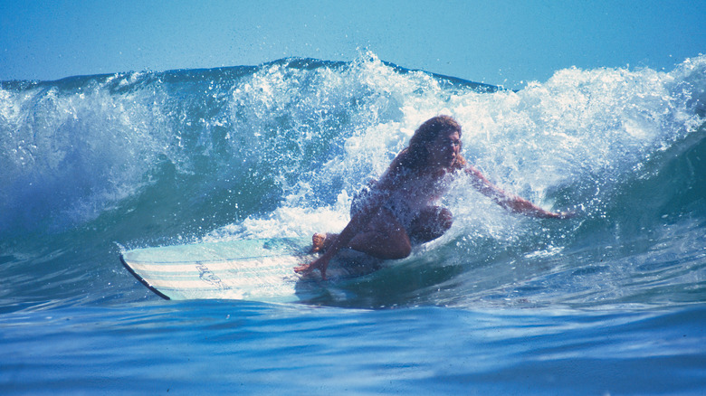 Girl surfing off the coast of La Ticla, Mexico