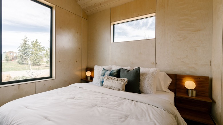 Cabin interior with bed at Yellowstone Peaks Hotel