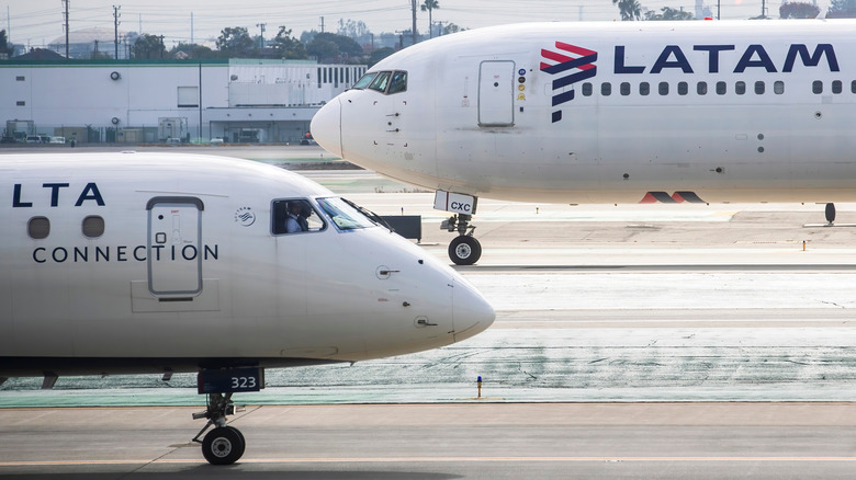 Two LATAM plans sitting staggered on the tarmac