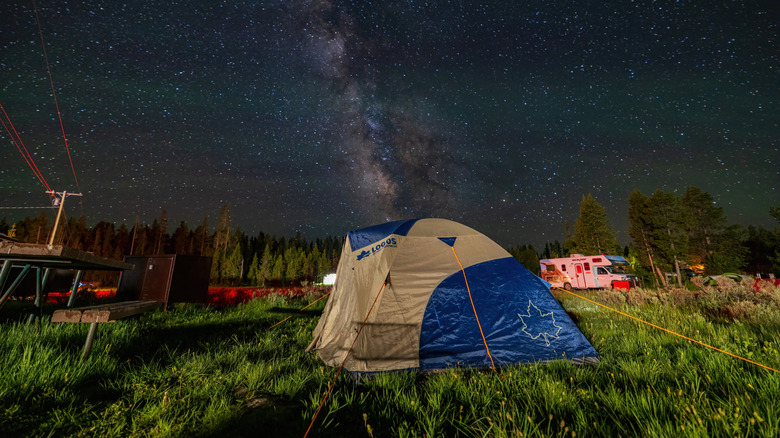 A tent in Bridge Bay Campground with a starry sky and views of the Milky Way Galaxy