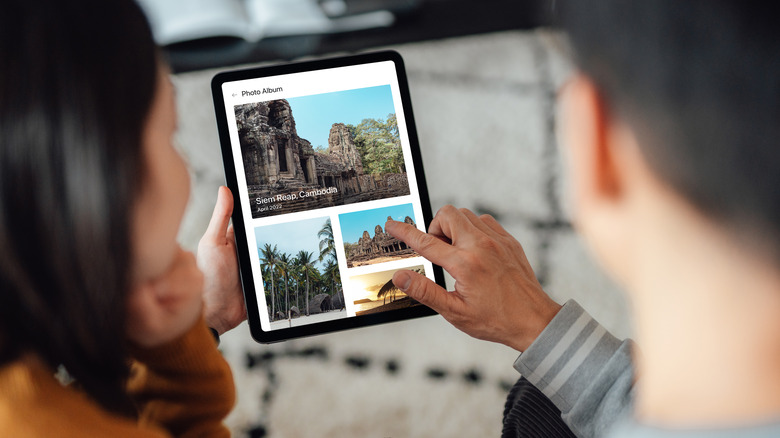 A couple looking at travel photos