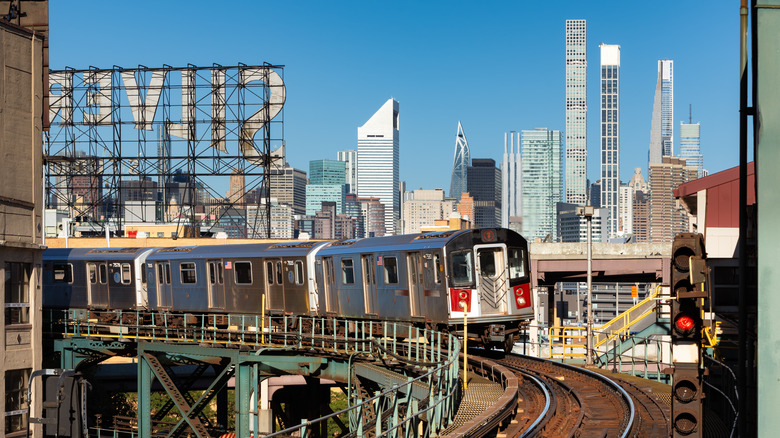 Above-ground MTA train in New York with skyscrapers in the background