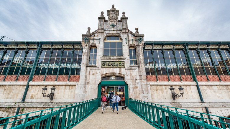 People walking into Esperanza Market in Santander, Spain