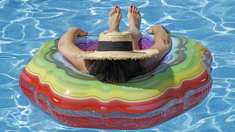 Woman floating on innertube in water