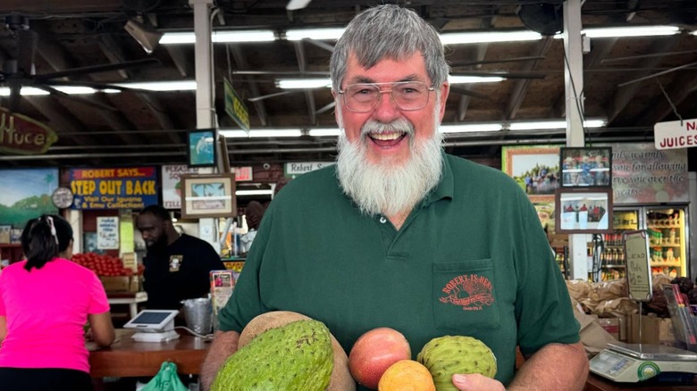 Robert holds a stash of his prized exotic fruit at Robert Is Here fruit stand