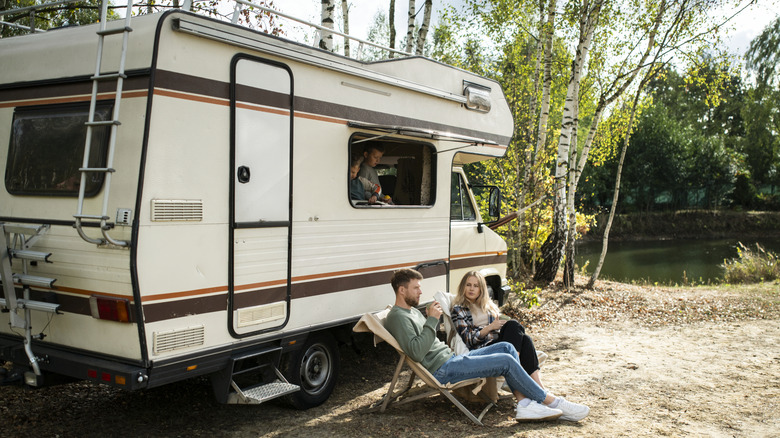 Family camping in an RV near water