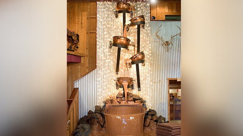 Five kettles pour chocolate as part of the largest chocolate waterfall in the world