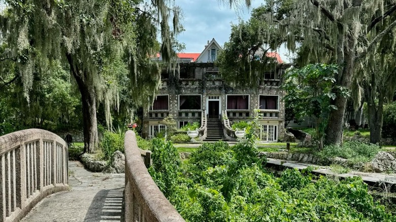 View of Wonder House from concrete bridge with plants and trees