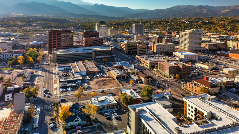 An aerial view of downtown Colorado Springs with the Ricky Mountains in the background