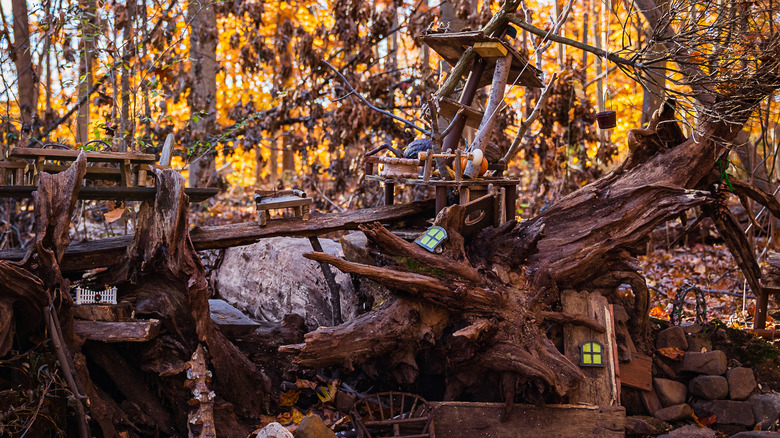 Miniature furniture placed among branches and logs on the South Mountain Fairy Trail in New Jersey