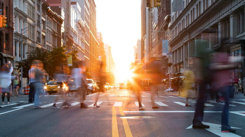 People crossing Fifth Avenue in NYC on a sunny day