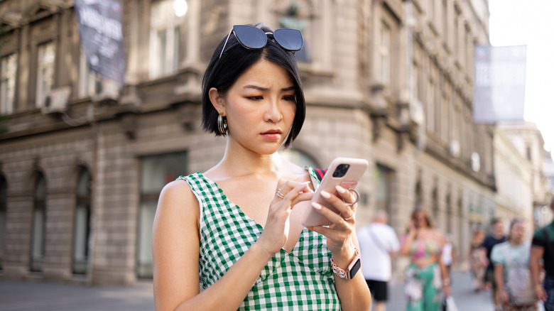 An annoyed traveler on her phone