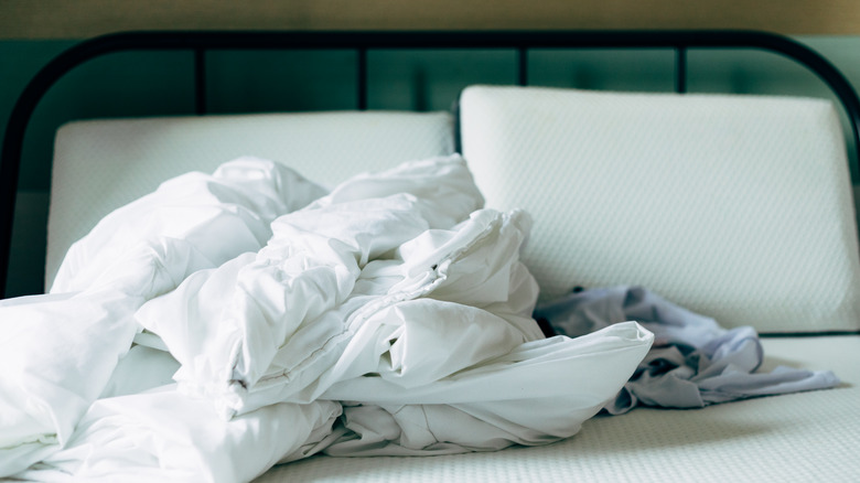 A pile of sheets on a bed