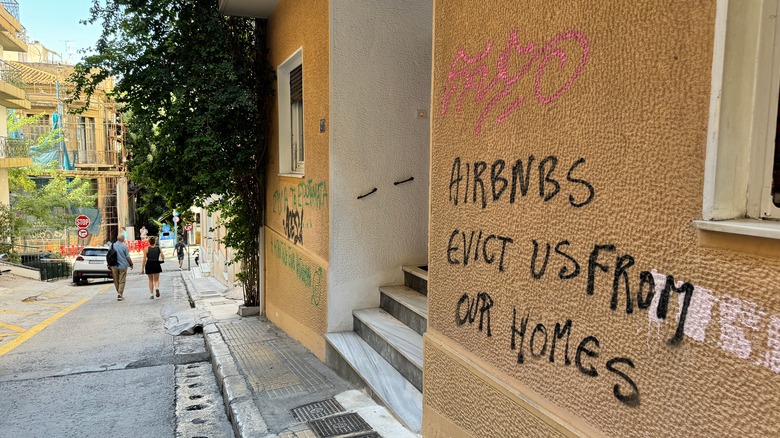 The side of a house tagged with anti-Airbnb graffiti