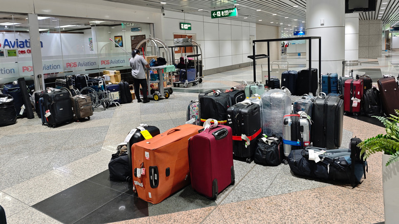 Lost luggage arranged on airport floor