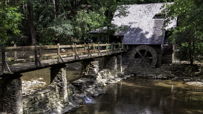 The Old Mill House in Mountain Brook, AL with a wooden bridge across Shades Creek.