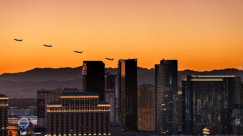 Planes taking off over a sunset above Las Vegas skyline