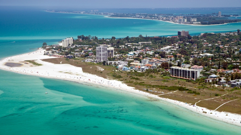 An aerial view of Siesta Key, Florida, including the beach and buildings