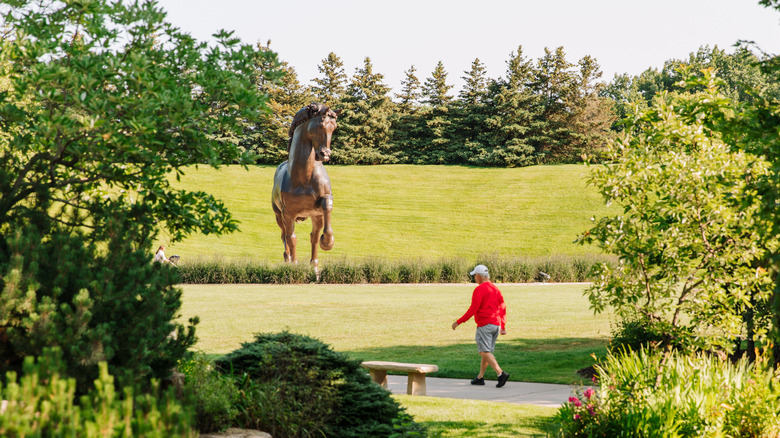 visitor seeing Nina Akamu's The American Horse at Meijer Gardens