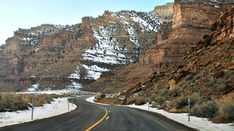 paved road winding into snowy Nine Mile Canyon in Utah