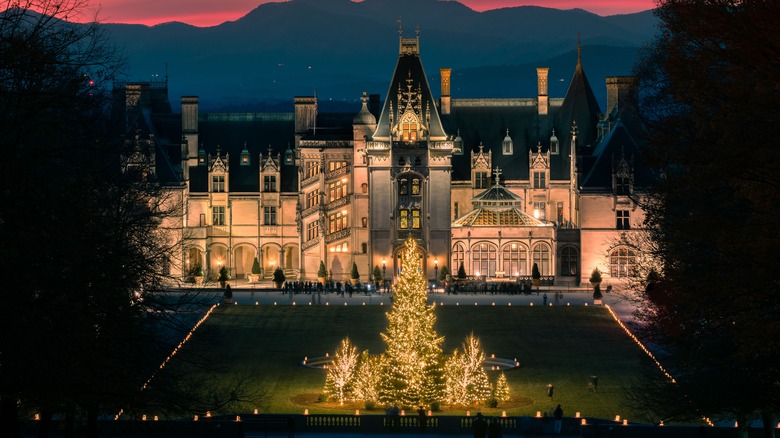 The outside of Biltmore Estate lit up at night