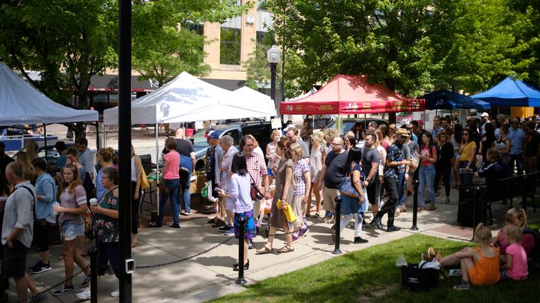 Shoppers at the Dale County Farmers' Market on a sunny day