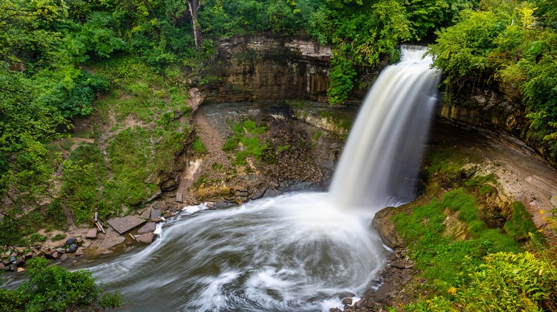 A waterfall among rocks and trees