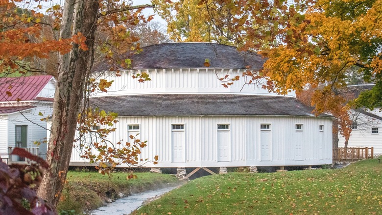 One of the large, white bath houses at Warms Springs Pools in fall