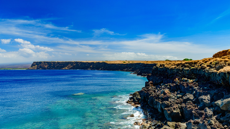Long cliffs above blue ocean